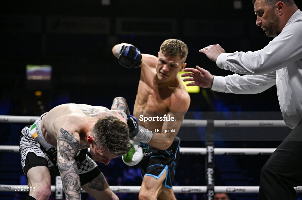 20 March 2026; Referee Eamonn Magill stops the fight between Codie Smith and Lee Gormley during their super featherweight bout at the SSE Arena in Belfast. Photo by David Fitzgerald/Sportsfile