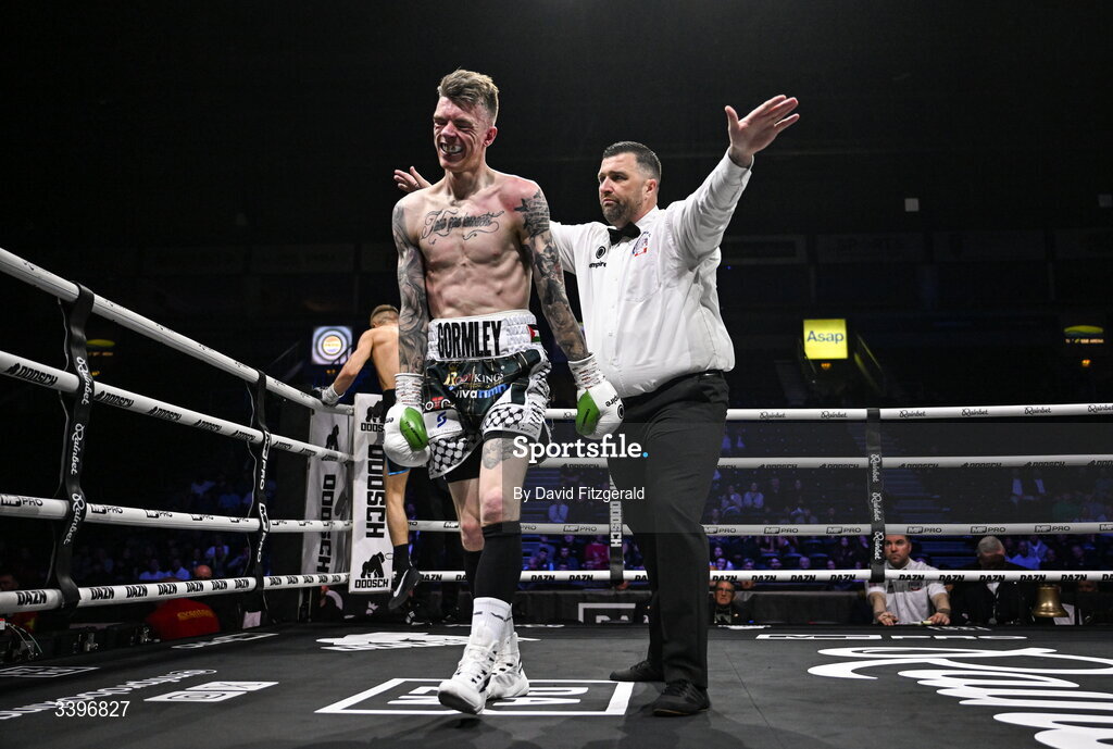 20 March 2026; Lee Gormley is led away by referee Eamonn Magill after the fight against Codie Smith was stopped during their super featherweight bout at the SSE Arena in Belfast. Photo by David Fitzgerald/Sportsfile