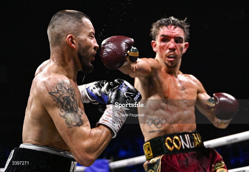 20 March 2026; Kavin Walsh, left, takes a punch from Michael Conlan during their WBC featherweight title fight at the SSE Arena in Belfast. Photo by David Fitzgerald/Sportsfile