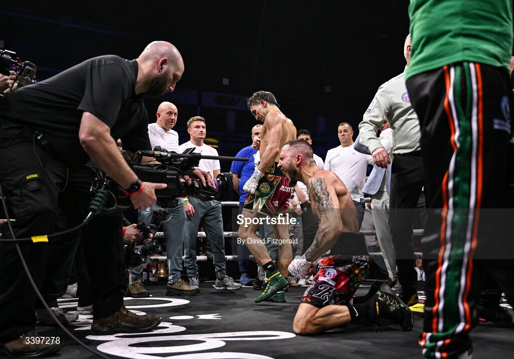 20 March 2026; Michael Conlan, left, walks away after being defeated by Kevin Walsh, centre, in their WBC featherweight title fight at the SSE Arena in Belfast. Photo by David Fitzgerald/Sportsfile