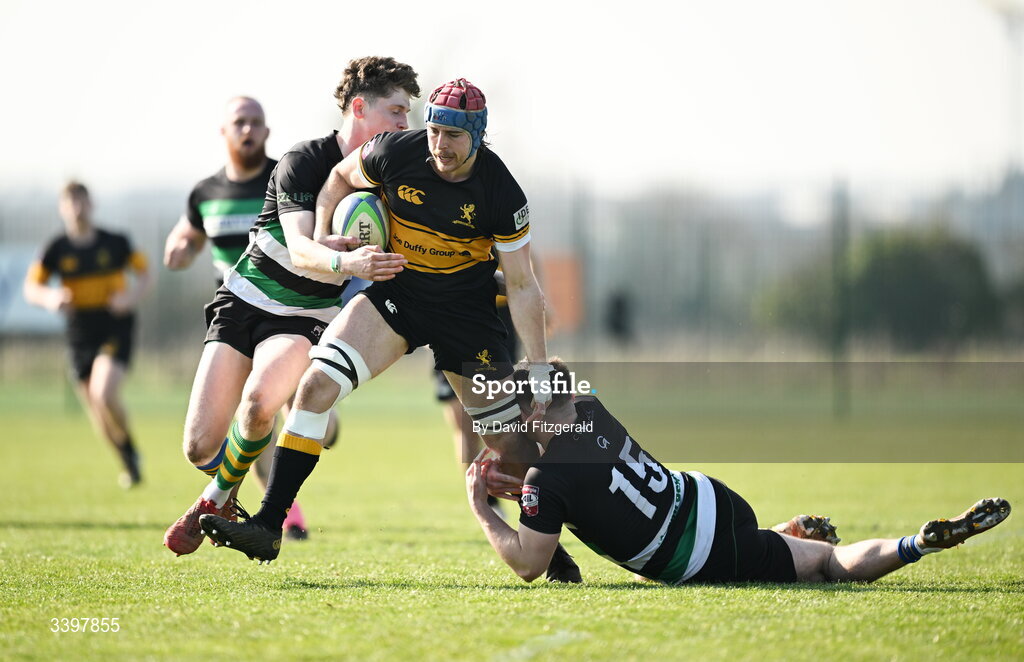 21 March 2026; Sam Lindeman of Malahide is tackled by Michael Connellan, left, and James McKeown of Clonmel during the Energia All-Ireland League Men's Division 2C match between Malahide RFC and Clonmel RFC at Malahide RFC on Estuary Road in Dublin. Photo by David Fitzgerald/Sportsfile