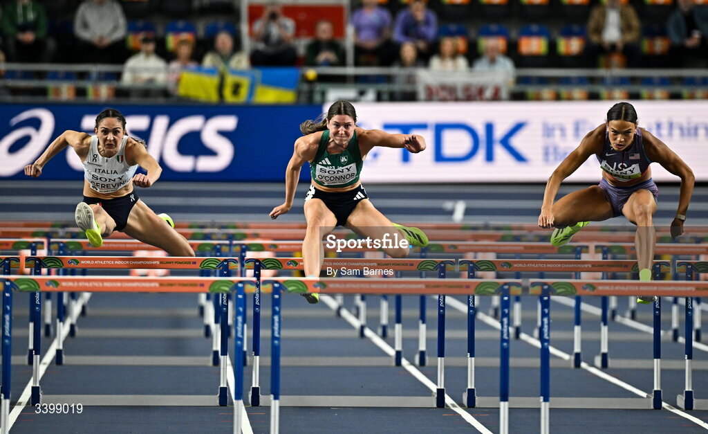 22 March 2026; Comptetitors, from left, Sveva Gerevini of Italy, Kate O'Connor of Ireland and Anna Hall of United States compete in the Women's 60m hurdles event in the Women's Pentathlon during day three of the World Athletics Indoor Championships at Kujawsko-Pomorska Arena in Torun, Poland. Photo by Sam Barnes/Sportsfile