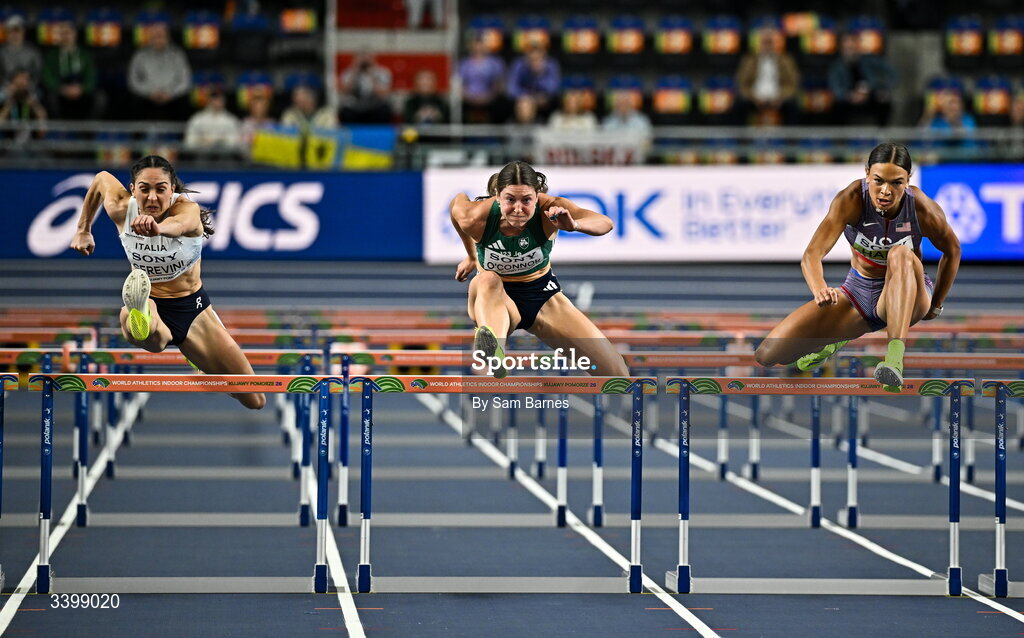22 March 2026; Comptetitors, from left, Sveva Gerevini of Italy, Kate O'Connor of Ireland and Anna Hall of United States compete in the Women's 60m hurdles event in the Women's Pentathlon during day three of the World Athletics Indoor Championships at Kujawsko-Pomorska Arena in Torun, Poland. Photo by Sam Barnes/Sportsfile