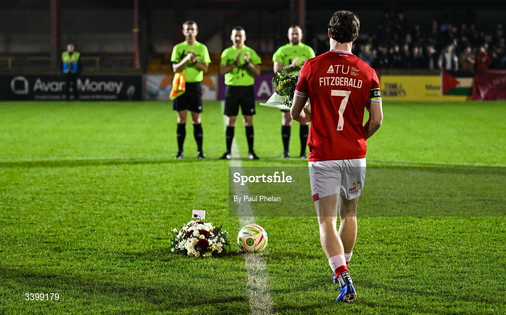 21 March 2026; Will Fitzgerald of Sligo Rovers walks flowers to place in the centre circle in memory of Sligo Rovers supporter Aaron Mulligan before the SSE Airtricity Men's Premier Division match between Sligo Rovers and Shelbourne at The Showgrounds in Sligo. Photo by Paul Phelan/Sportsfile