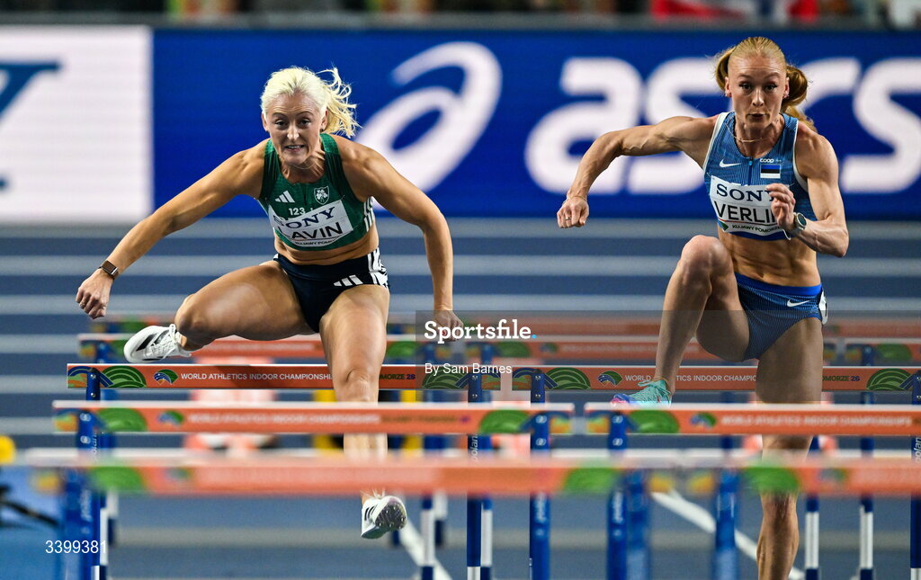 22 March 2026; Sarah Lavin of Ireland, left, and Kreete Verlin of Estonia compete in the Women's 60m hurdles heat during day three of the World Athletics Indoor Championships at Kujawsko-Pomorska Arena in Torun, Poland. Photo by Sam Barnes/Sportsfile