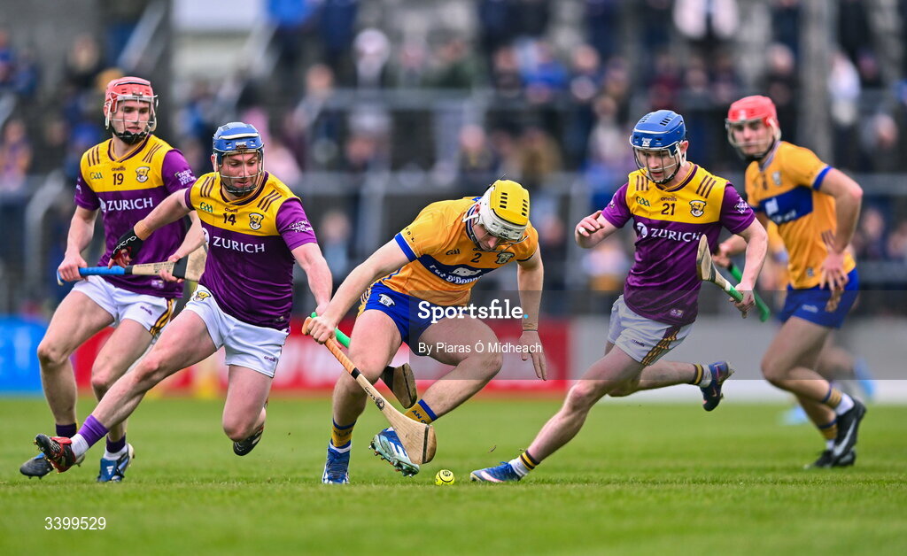 8 March 2026; Ronan Kilroy of Clare in action against Wexford players, from left, Diarmuid O’Leary, Kevin Foley and Corey Byrne Dunbar during the Allianz Hurling League Division 1B match between Clare and Wexford at Zimmer Biomet Páirc Chíosóg in Ennis, Clare. Photo by Piaras Ó Mídheach/Sportsfile