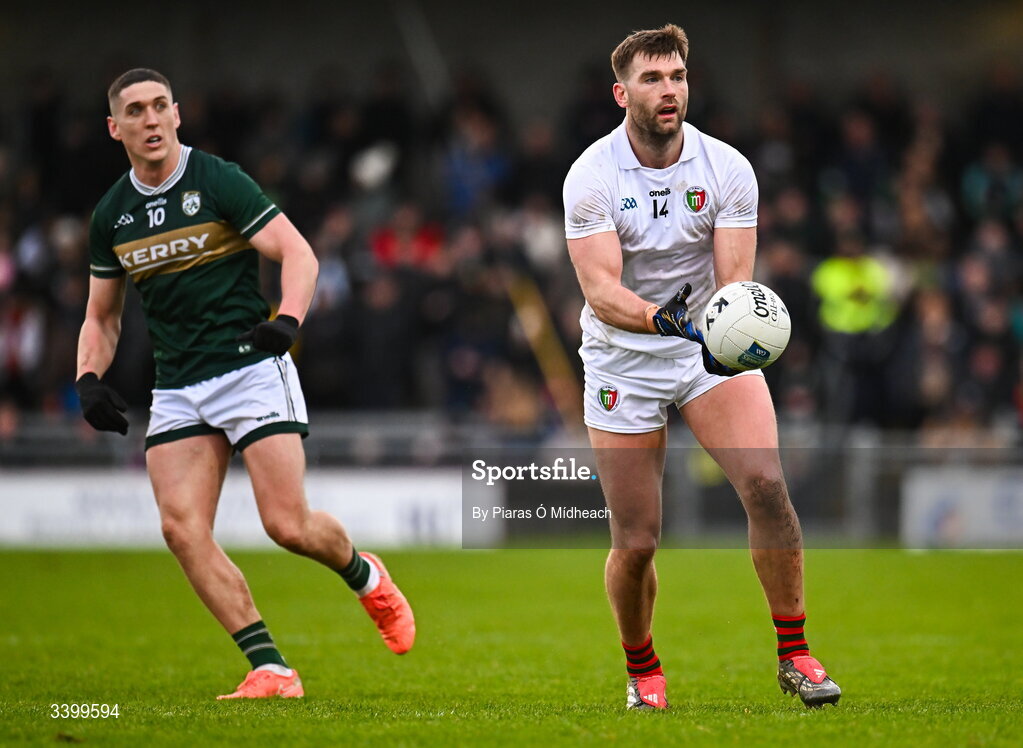 14 March 2026; Aidan O'Shea of Mayo passes as Joe O'Connor of Kerry looks on during the Allianz Football League Division 1 match between Kerry and Mayo at Austin Stack Park in Tralee, Kerry. Photo by Piaras Ó Mídheach/Sportsfile