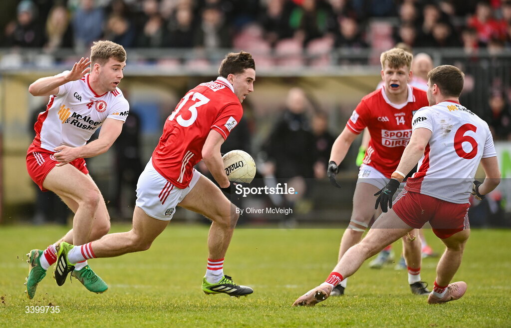 22 March 2026; Chris Og Jones of Cork in action against Cormac Quinn and Niall Devlin of Tyrone during the Allianz Football League Division 2 match between Tyrone and Cork at O'Neills Healy Park in Omagh, Tyrone. Photo by Oliver McVeigh/Sportsfile