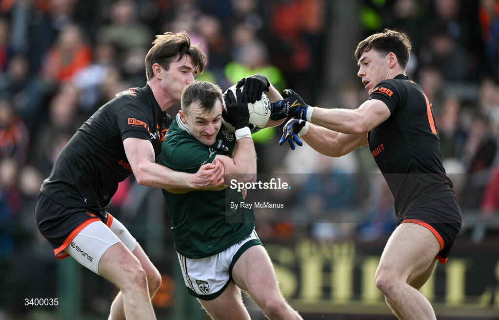 22 March 2026; Tom O'Sullivan of Kerry is tackled by Ben Crealey, left, and Darragh McMullen of Armagh during the Allianz Football League Division 1 match between Armagh and Kerry at BOX-IT Athletic Grounds in Armagh. Photo by Ray McManus/Sportsfile
