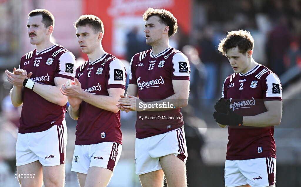 22 March 2026; Galway players, from left, Céin D'Arcy, Dylan McHugh, Robert Finnerty and Johnny McGrath applaud after a minute's silence for the late Michael Lyster, former RTÉ and Sunday Game broadcaster who died today, before the Allianz Football League Division 1 match between Galway and Dublin at Pearse Stadium in Galway. Photo by Piaras Ó Mídheach/Sportsfile