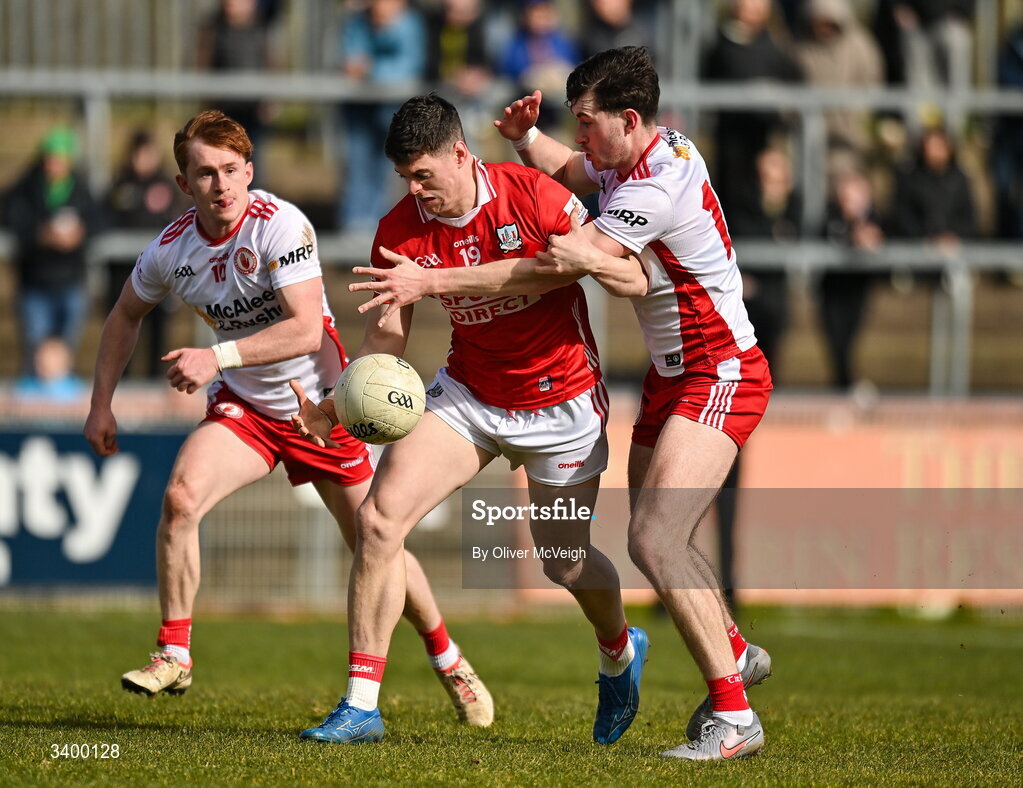 22 March 2026; Rory Maguire of Cork in action against Seanie O"Donnell and Ciaran Daly of Tyrone during the Allianz Football League Division 2 match between Tyrone and Cork at O'Neills Healy Park in Omagh, Tyrone. Photo by Oliver McVeigh/Sportsfile
