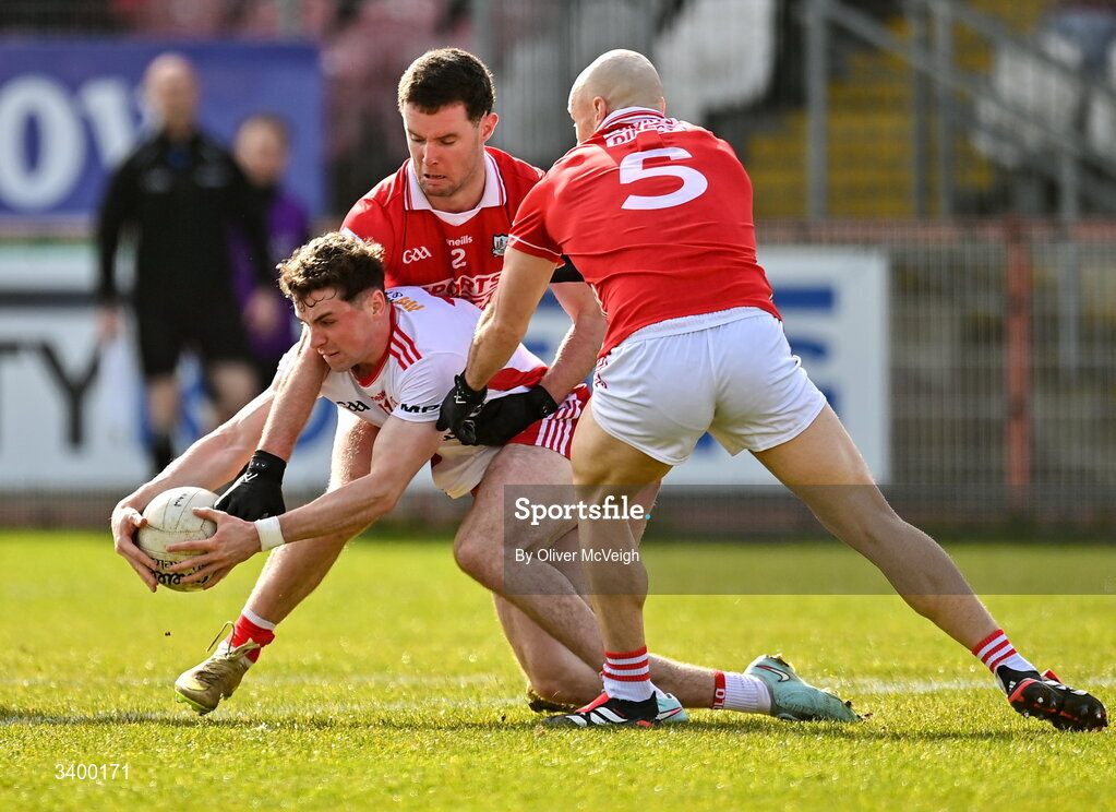 22 March 2026; Ronan Cassidy of Tyrone in action against Maurice Shanley and Brian O'Driscoll of Cork during the Allianz Football League Division 2 match between Tyrone and Cork at O'Neills Healy Park in Omagh, Tyrone. Photo by Oliver McVeigh/Sportsfile