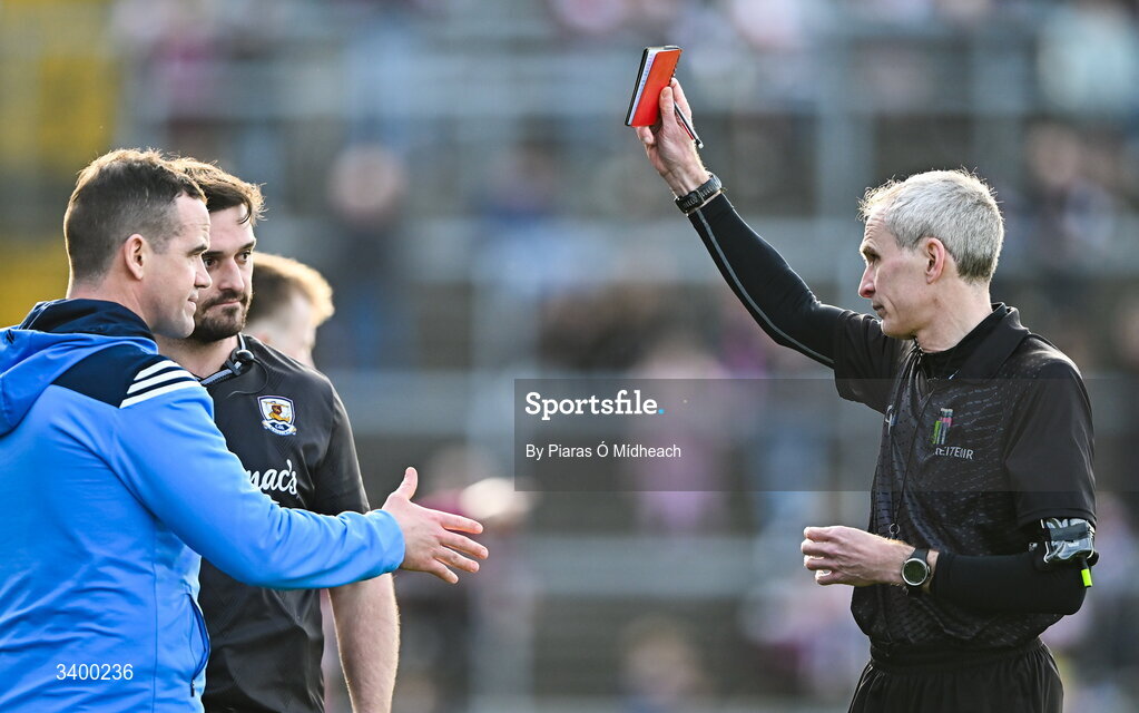 22 March 2026; Referee Fergal Kelly shows the red card to Dublin manager Ger Brennan and to Galway strength and conditioning coach Cian Breathnach McGinn before the start of the second half, during the Allianz Football League Division 1 match between Galway and Dublin at Pearse Stadium in Galway. Photo by Piaras Ó Mídheach/Sportsfile