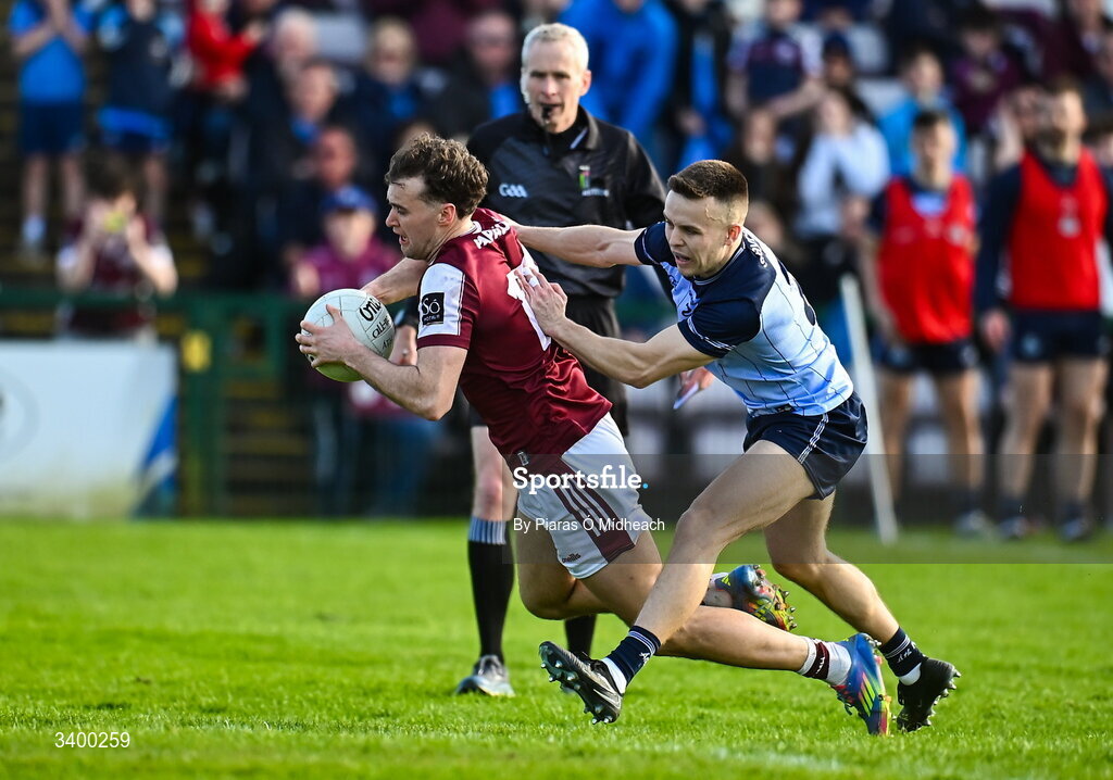 22 March 2026; Robert Finnerty of Galway is tackled by Eoin Murchan of Dublin after Finnerty's penalty was saved, but a second penalty wasn't awarded, during the Allianz Football League Division 1 match between Galway and Dublin at Pearse Stadium in Galway. Photo by Piaras Ó Mídheach/Sportsfile