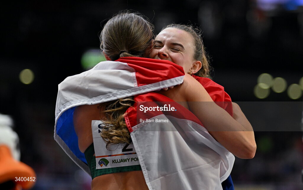 22 March 2026; Kate O'Connor of Ireland, left, with Sofie Dokter of Netherlands embrace after the Women's Pentathlon during day three of the World Athletics Indoor Championships at Kujawsko-Pomorska Arena in Torun, Poland. Photo by Sam Barnes/Sportsfile
