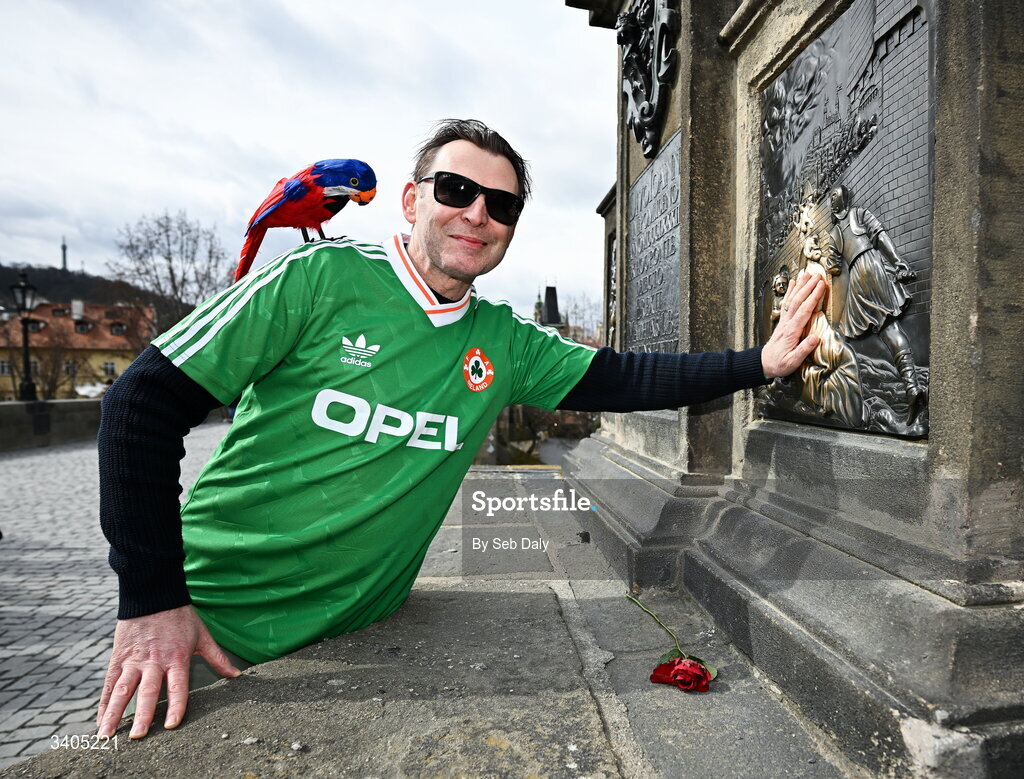 26 March 2026; Lenny McCarthy, from Douglas, Cork, with a "parrot" on his shoulder touches the Statue of John of Nepomuk, the oldest and only bronze figure, on the Charles Bridge, which is said to bring good fortune before the FIFA World Cup 2026 European Qualifiers play-off semi-final match between Czechia and Republic of Ireland at Fortuna Arena in Prague, Czechia. Photo by Seb Daly/Sportsfile