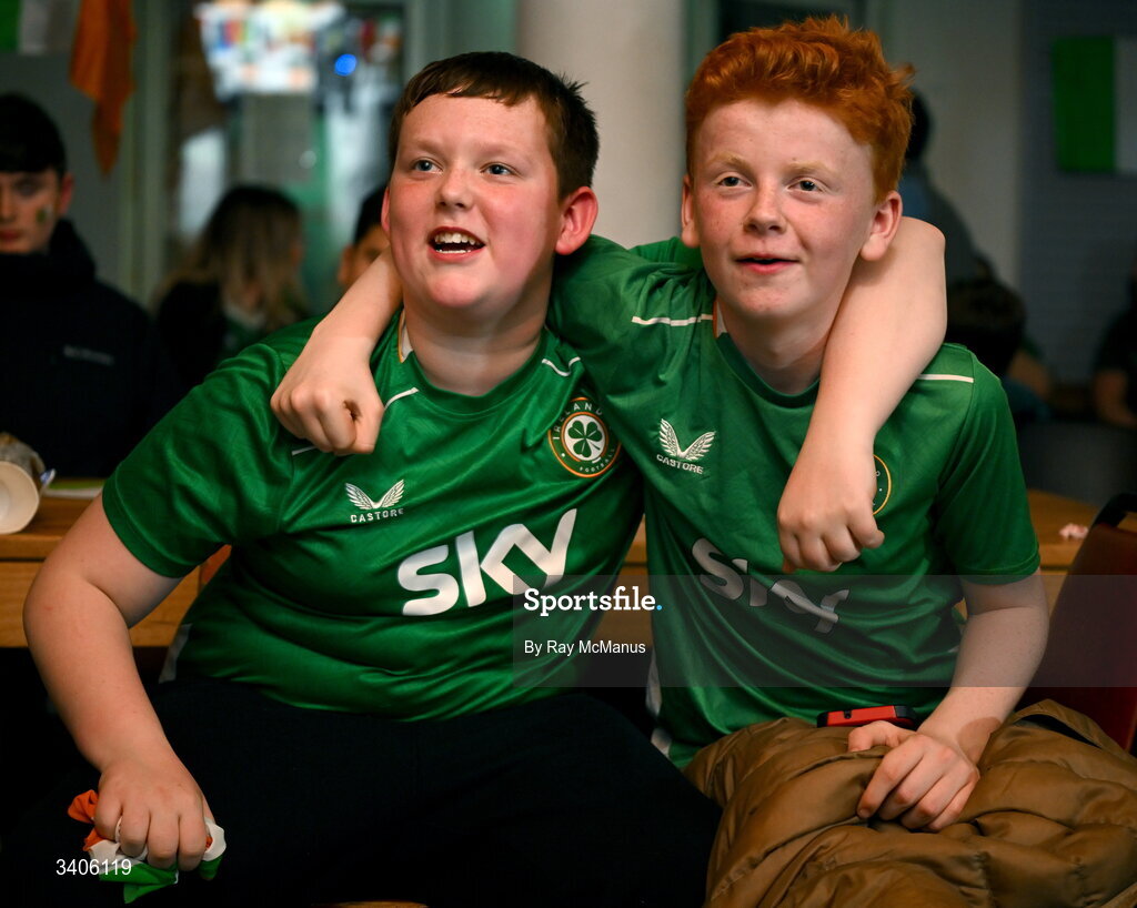26 March 2026; Republic of Ireland supporters Jessie Loj, left, and Cameron Kinsella react as they watch the FIFA World Cup 2026 European Qualifiers play-off semi-final match between Czechia and Republic of Ireland at Fortuna Arena in Prague, Czechia, on a giant screen in O'Connell Secondary School, North Circular Road in Dublin. Photo by Ray McManus/Sportsfile