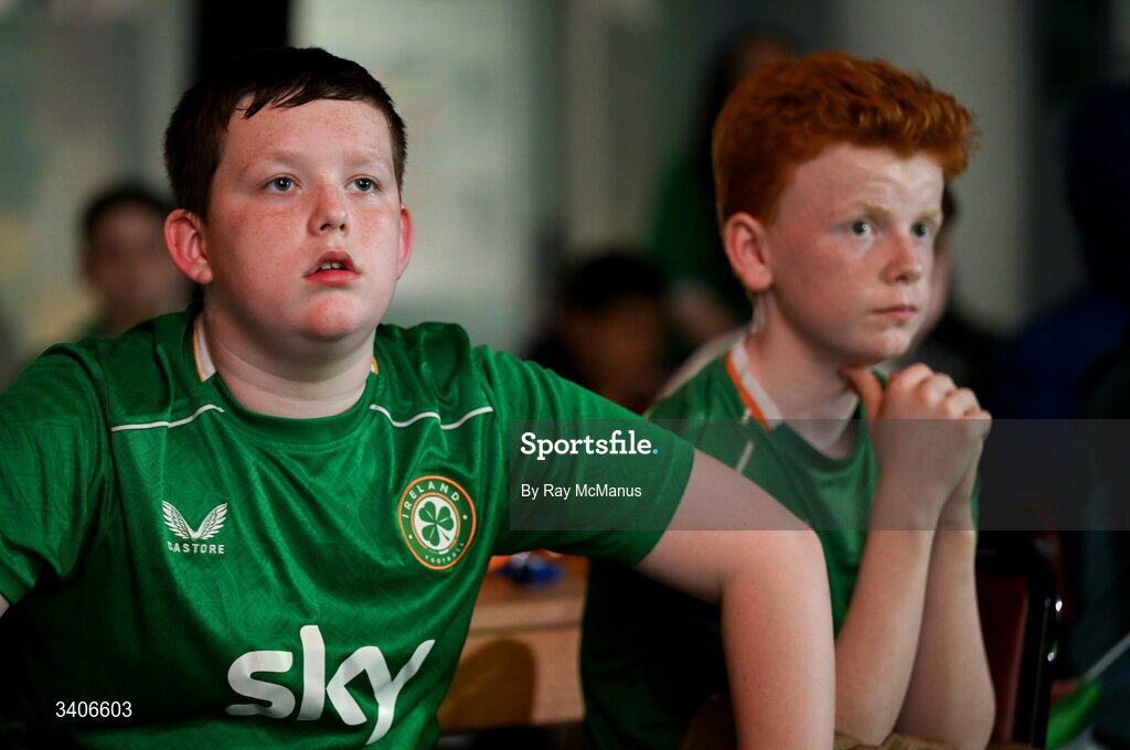26 March 2026; Republic of Ireland supporters, Jessie Loj, left, and Cameron Kinsella, react as they watch the FIFA World Cup 2026 European Qualifiers play-off semi-final match between Czechia and Republic of Ireland at Fortuna Arena in Prague, Czechia, on a giant screen in O'Connell Secondary School, North Circular Road in Dublin. Photo by Ray McManus/Sportsfile
