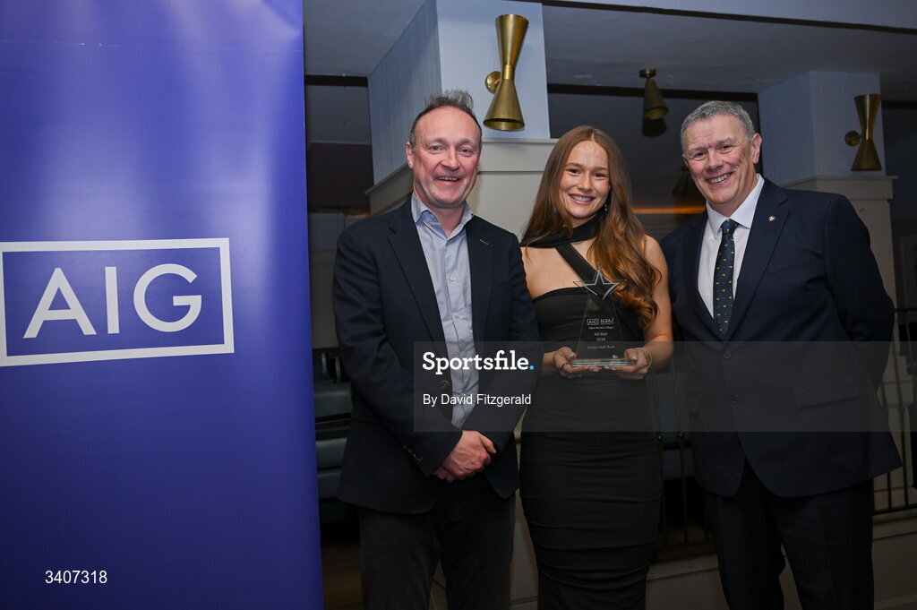 27 March 2026; Niamh Divilly of TUD is presented with her 2026 AIG HEC All Star award by Seán Fleming, Chairperson Ladies HEC and John Gillick, Head of Consumer Marketing and Sponsorship, AIG Ireland, at the 2026 AIG HEC All-Stars and Rising Stars evening, at the Dublin Bonnington Hotel. Photo by David Fitzgerald/Sportsfile