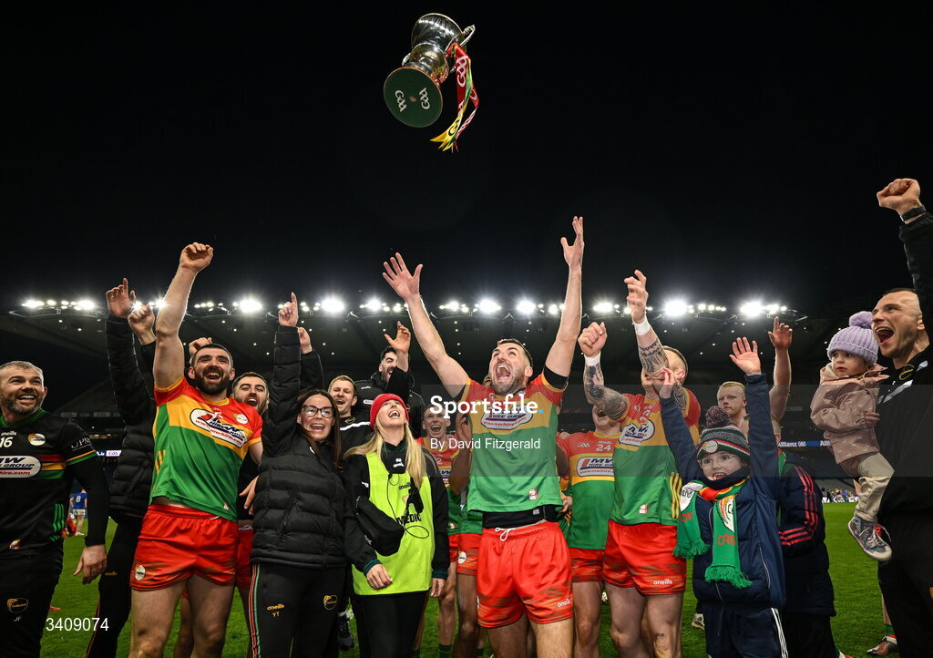 28 March 2026; Carlow players and staff celebrate with the cup after the Allianz Football League Division 4 final match between Carlow and Longford at Croke Park in Dublin. Photo by David Fitzgerald/Sportsfile