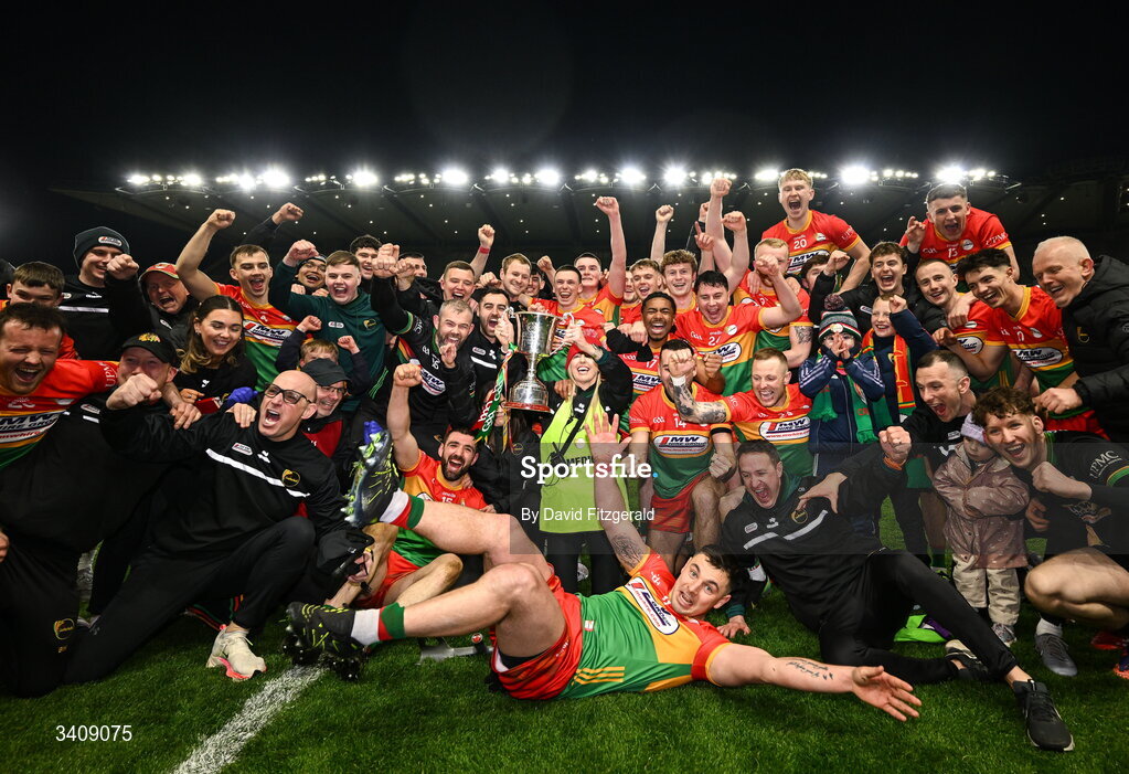 28 March 2026; Carlow players and staff celebrate with the cup after the Allianz Football League Division 4 final match between Carlow and Longford at Croke Park in Dublin. Photo by David Fitzgerald/Sportsfile