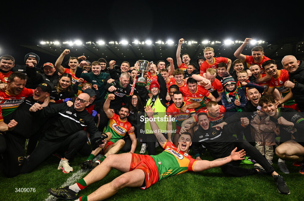28 March 2026; Carlow players and staff celebrate with the cup after the Allianz Football League Division 4 final match between Carlow and Longford at Croke Park in Dublin. Photo by David Fitzgerald/Sportsfile