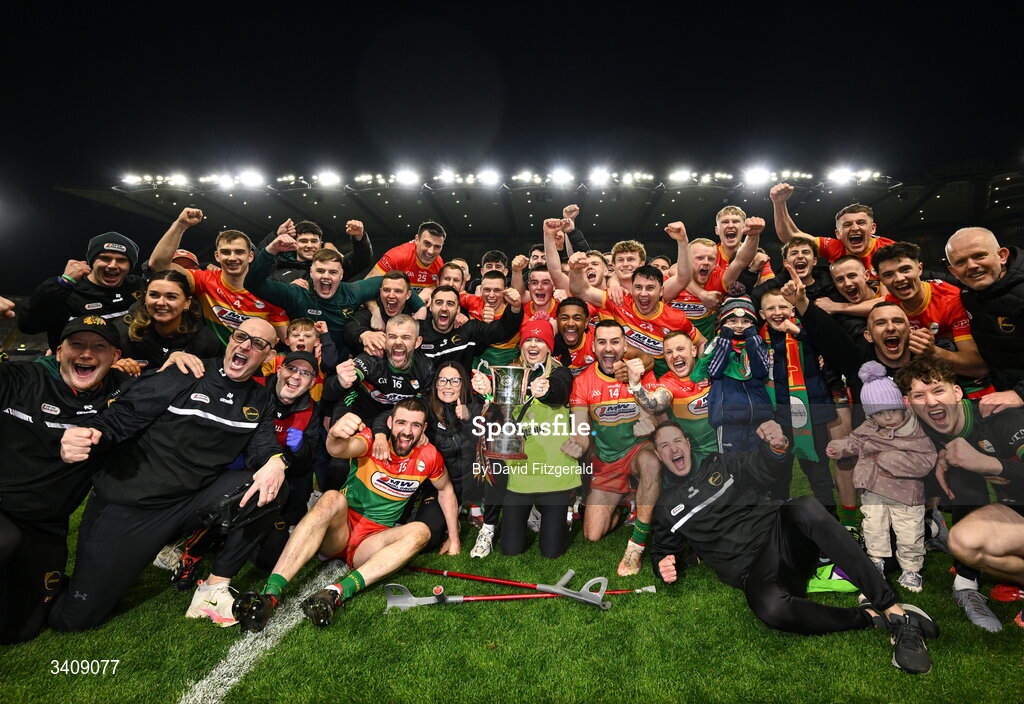 28 March 2026; Carlow players and staff celebrate with the cup after the Allianz Football League Division 4 final match between Carlow and Longford at Croke Park in Dublin. Photo by David Fitzgerald/Sportsfile