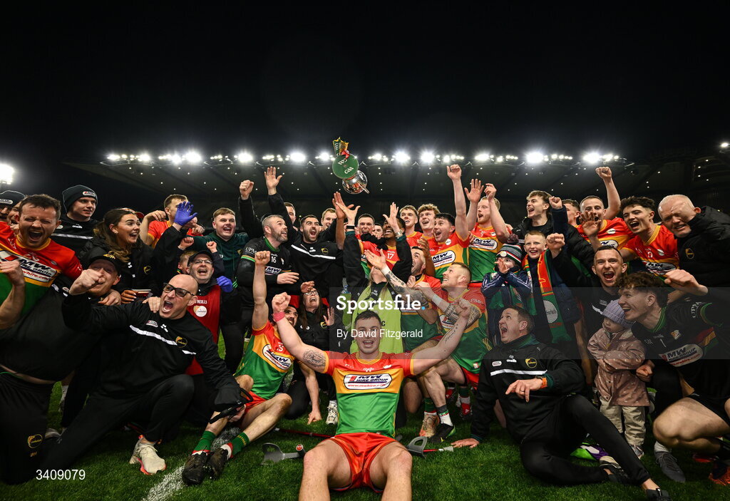 28 March 2026; Carlow players and staff celebrate with the cup after the Allianz Football League Division 4 final match between Carlow and Longford at Croke Park in Dublin. Photo by David Fitzgerald/Sportsfile