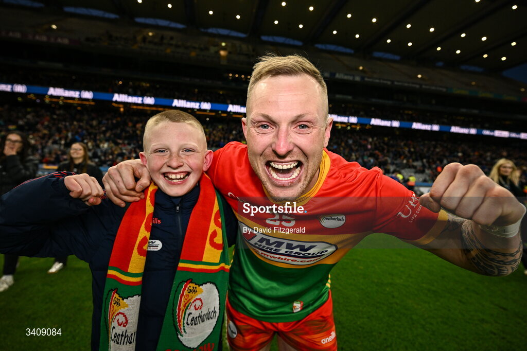 28 March 2026; Lee Walker of Carlow celebrates with his son Drake after the Allianz Football League Division 4 final match between Carlow and Longford at Croke Park in Dublin. Photo by David Fitzgerald/Sportsfile