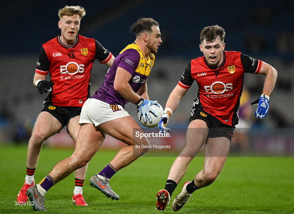 28 March 2026; Dylan Furlong of Wexford in action against Callum Rogers, right, and Adam Crimmins of Down during the Allianz Football League Division 3 final match between Down and Wexford at Croke Park in Dublin. Photo by David Fitzgerald/Sportsfile