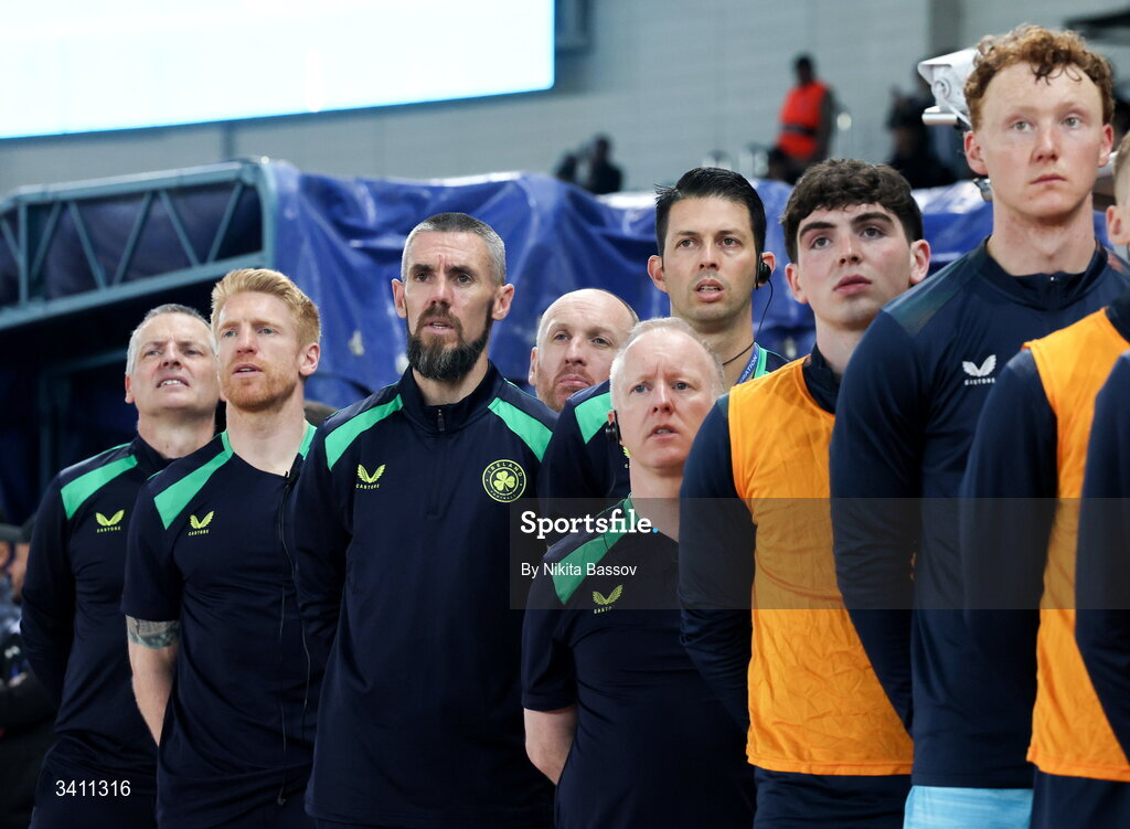 31 March 2026; Republic of Ireland manager Jim Crawford, left, coach Paul McShane with backroom staff and players during the national anthem before the UEFA European U21 Championship qualifier match between Kazakhstan and Republic of Ireland at Turkistan Arena in Turkeistan, Kazakhstan. Photo by Nikita Bassov/Sportsfile