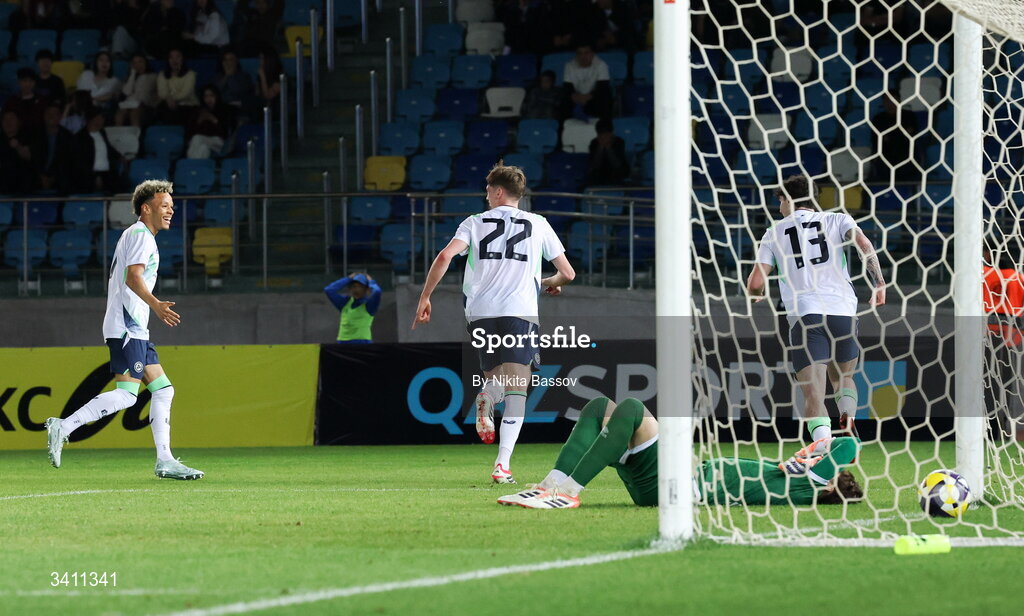 31 March 2026; Oisin Gallagher of Republic of Ireland, centre, runs to celebrate with teammates Trent Kone-Doherty, left, and Sean Patton after scoring his side's first goal during the UEFA European U21 Championship qualifier match between Kazakhstan and Republic of Ireland at Turkistan Arena in Turkeistan, Kazakhstan. Photo by Nikita Bassov/Sportsfile