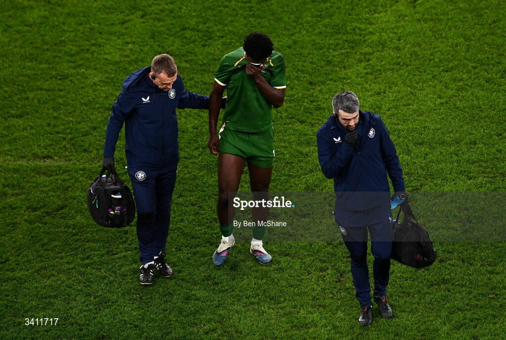 31 March 2026; James Abankwah of Republic of Ireland leaves the pitch, accompanied by lead physiotherapist Danny Miller and team doctor Sean Carmody, right, with an injury during the international friendly match between Republic of Ireland and North Macedonia at Aviva Stadium in Dublin. Photo by Ben McShane/Sportsfile