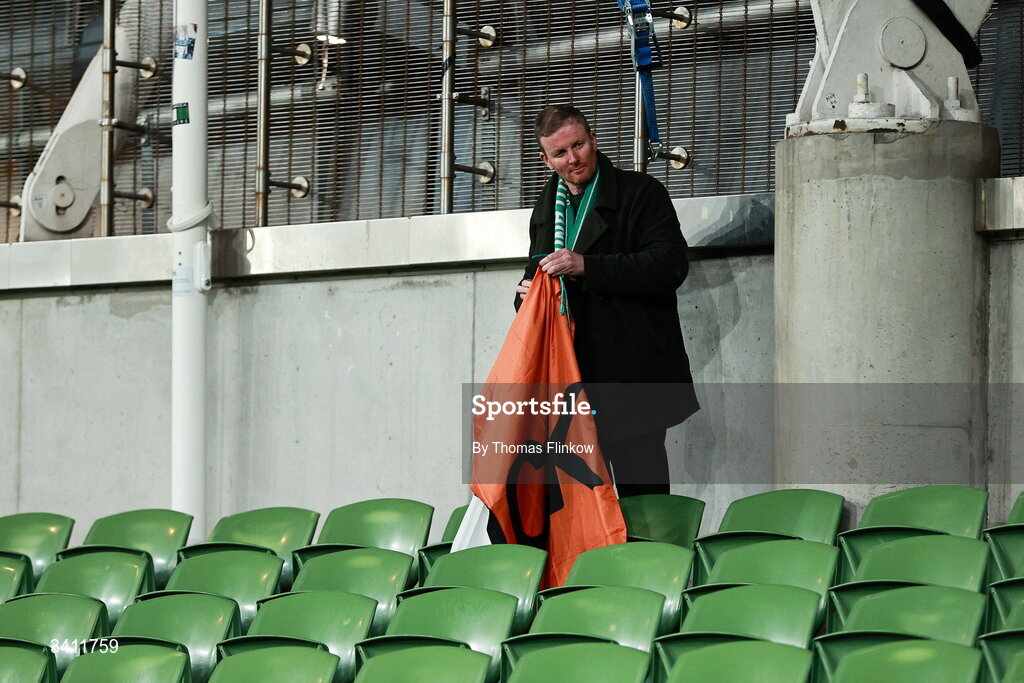 31 March 2026; A Republic of Ireland supporter folds his flag after the drawn international friendly match between Republic of Ireland and North Macedonia at Aviva Stadium in Dublin. Photo by Thomas Flinkow/Sportsfile