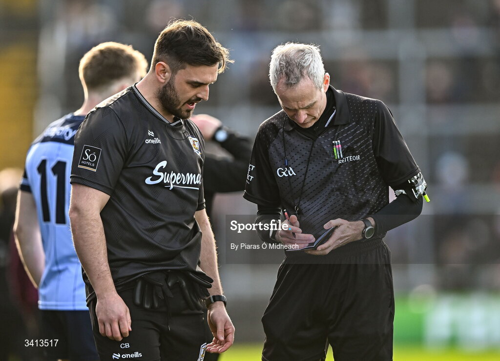 22 March 2026; Referee Fergal Kelly takes the name of Galway strength and conditioning coach Cian Breathnach McGinn before sending him off before the start of the second half during the Allianz Football League Division 1 match between Galway and Dublin at Pearse Stadium in Galway. Photo by Piaras Ó Mídheach/Sportsfile