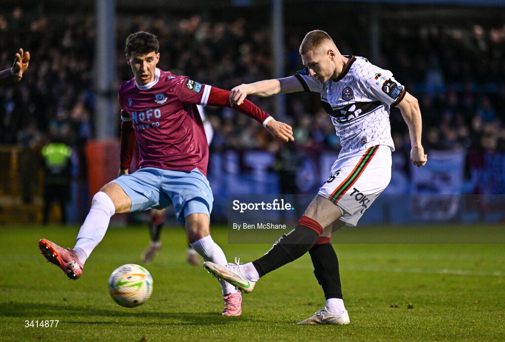 3 April 2026; Ross Tierney of Bohemians has a shot on goal despite the tackle of Ethan O'Brien of Drogheda United during the SSE Airtricity Men's Premier Division match between Drogheda United and Bohemians at Sullivan & Lambe Park in Drogheda, Louth. Photo by Ben McShane/Sportsfile