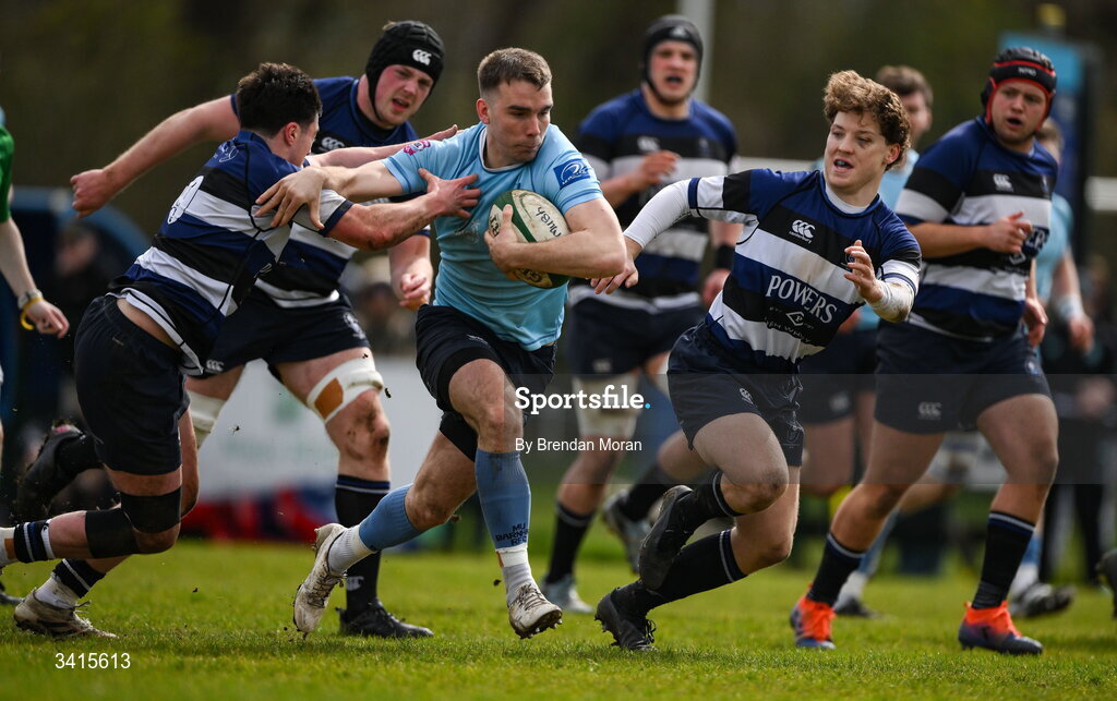 4 April 2026; Shane Mallon of MU Barnhall is tackled by Dylan Kelly and Louis McDonagh of Wanderers during the Energia Men's All-Ireland League Division match between MU Barnhall and Wanderers RFC at MU Barnhall RFC in Parsonstown, Kildare. Photo by Brendan Moran/Sportsfile