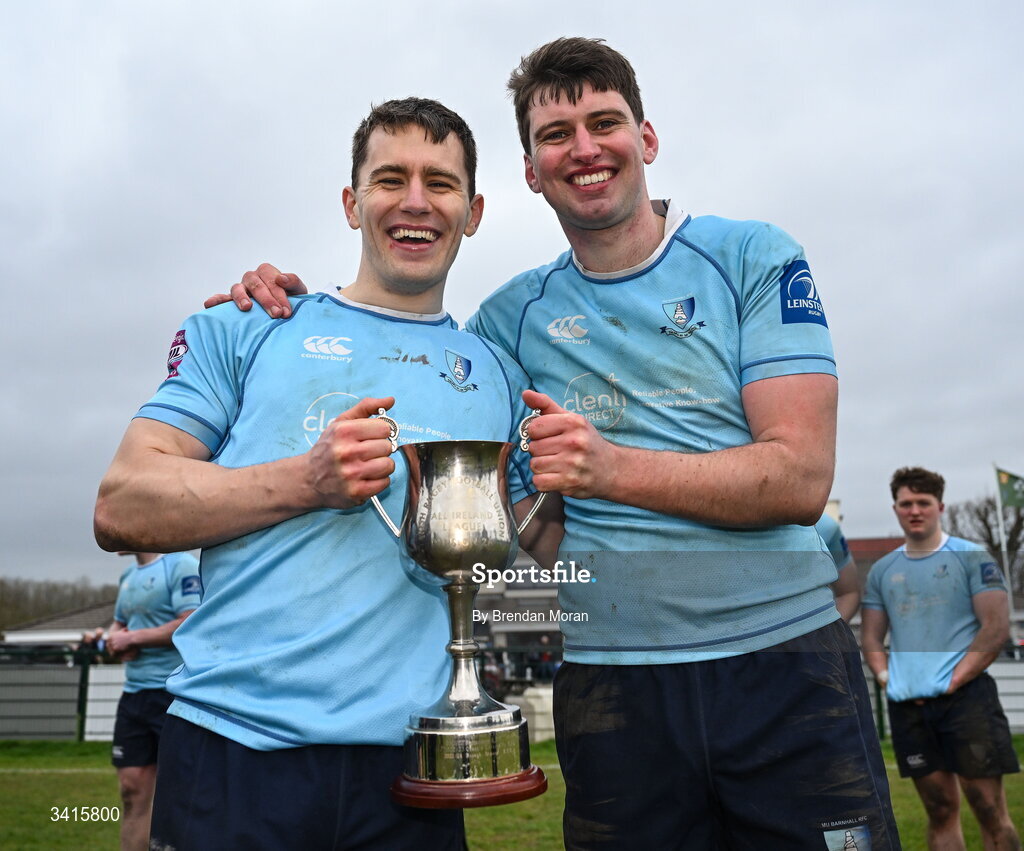 4 April 2026; MU Barnhall players Conor Neville, left, and Cathal Duff celebrate with the Energia AIL Division 2 trophy after the Energia Men's All-Ireland League Division match between MU Barnhall and Wanderers RFC at MU Barnhall RFC in Parsonstown, Kildare. Photo by Brendan Moran/Sportsfile