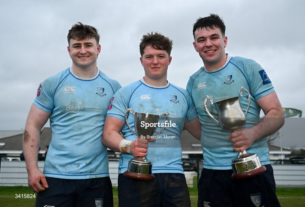 4 April 2026; MU Barnhall players, from left, Eoin Kelly, Finn Brien and Dan Murphy celebrate with the Energia AIL Division 2 trophy after the Energia Men's All-Ireland League Division match between MU Barnhall and Wanderers RFC at MU Barnhall RFC in Parsonstown, Kildare. Photo by Brendan Moran/Sportsfile