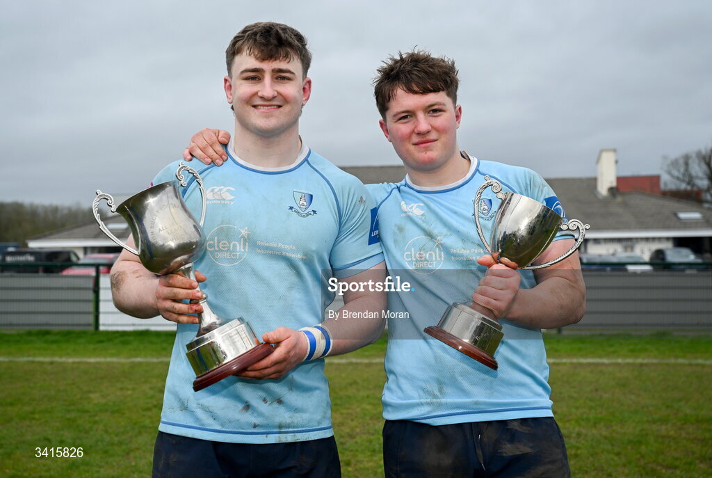 4 April 2026; MU Barnhall players Eoin Kelly, left, and Finn Brien celebrate with the Energia AIL Division 2 trophy after the Energia Men's All-Ireland League Division match between MU Barnhall and Wanderers RFC at MU Barnhall RFC in Parsonstown, Kildare. Photo by Brendan Moran/Sportsfile