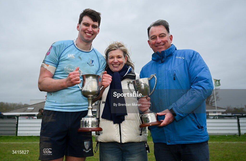 4 April 2026; Jack Hannon of MU Barnhall celebrates with his parents Roseanne and Clem and the Energia AIL Division 2 trophy after the Energia Men's All-Ireland League Division match between MU Barnhall and Wanderers RFC at MU Barnhall RFC in Parsonstown, Kildare. Photo by Brendan Moran/Sportsfile