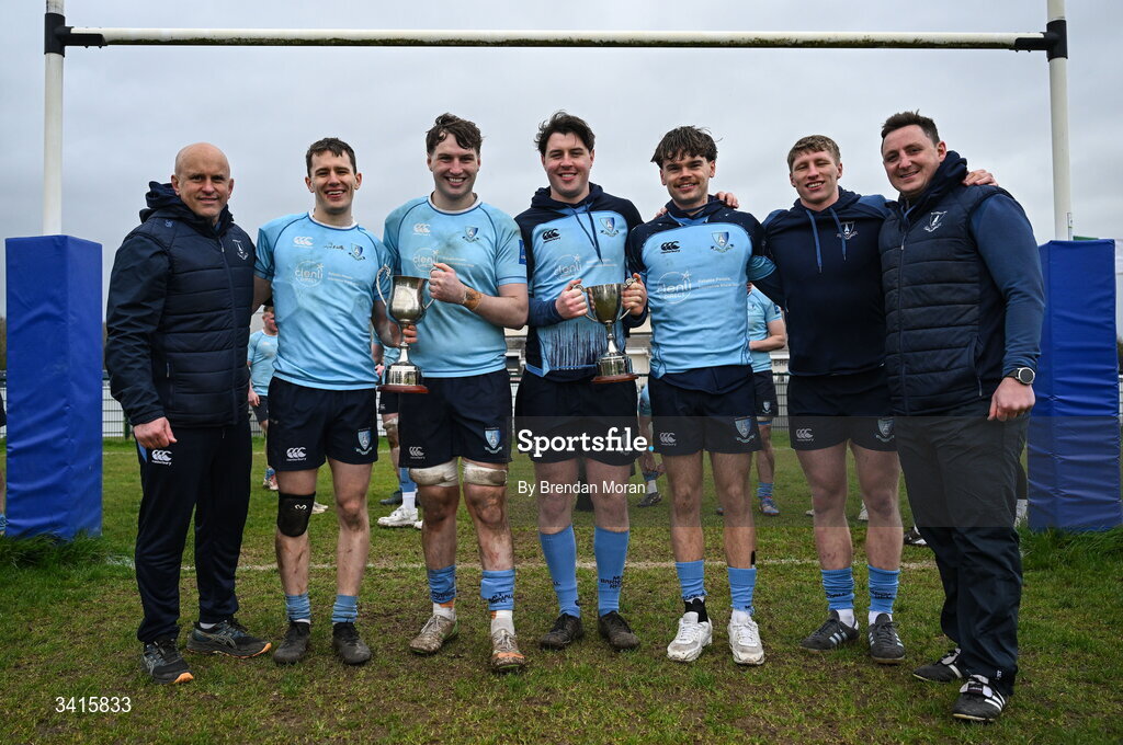 4 April 2026; MU Barnhall coaches Adrian Flavin, left, and Darren Hudson celebrate with players, from second from left, Conor Neville, Stephen Callanan, Luke Callanan, Michael Byrne and Conor Duggan and the Energia AIL Division 2 trophy after the Energia Men's All-Ireland League Division match between MU Barnhall and Wanderers RFC at MU Barnhall RFC in Parsonstown, Kildare. Photo by Brendan Moran/Sportsfile