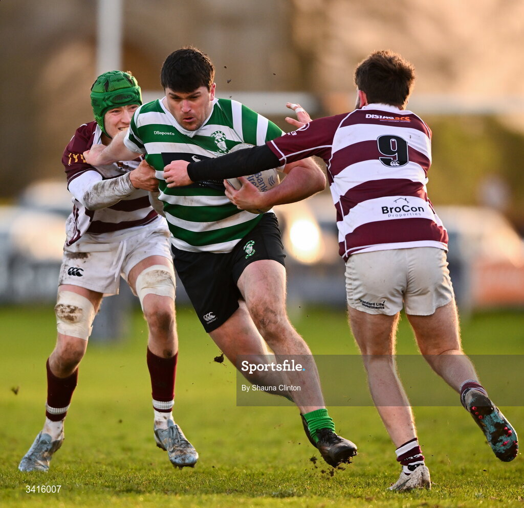 4 April 2026; David Butler of Naas RFC is tackled by Tullow RFC players Tom Hughes, left, and Cian Leonard during the Bank of Ireland Provincial Towns Cup semi-final match between Naas RFC and Tullow RFC at County Carlow RFC in Oakpark, Carlow. Photo by Shauna Clinton/Sportsfile
