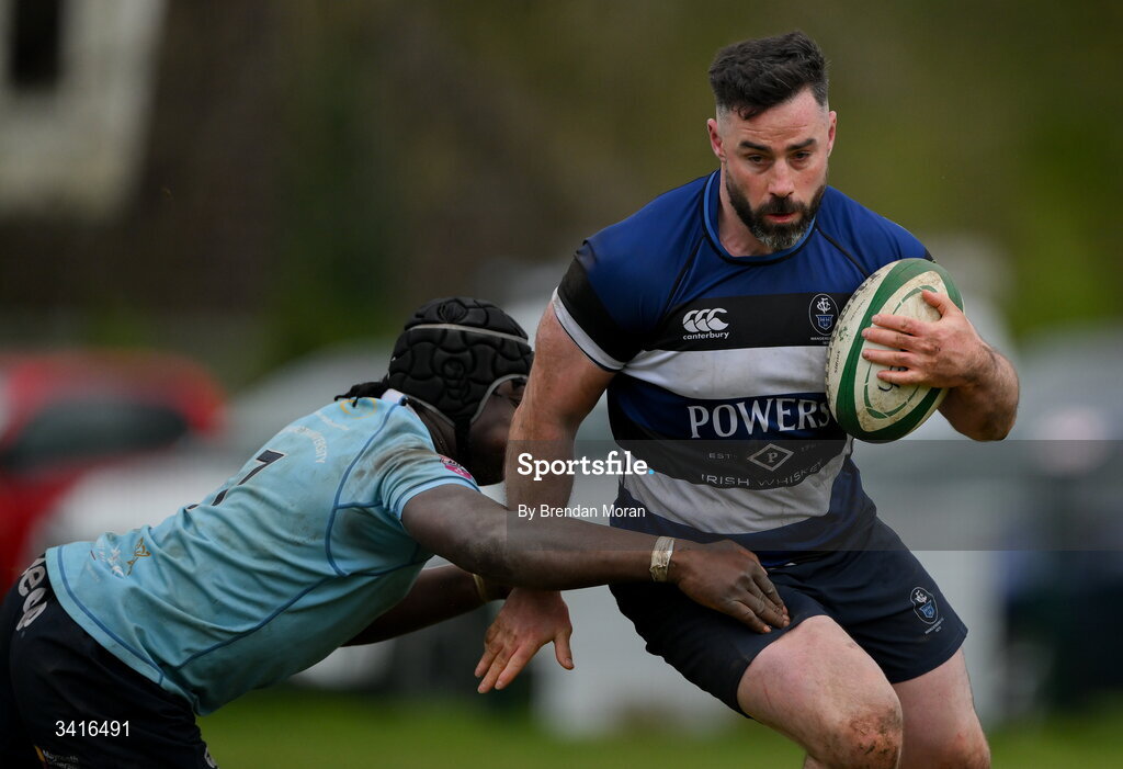 4 April 2026; Mick McGrath of Wanderers is tackled by Abdul Olaosebikan of MU Barnhall during the Energia Men's All-Ireland League Division match between MU Barnhall and Wanderers RFC at MU Barnhall RFC in Parsonstown, Kildare. Photo by Brendan Moran/Sportsfile