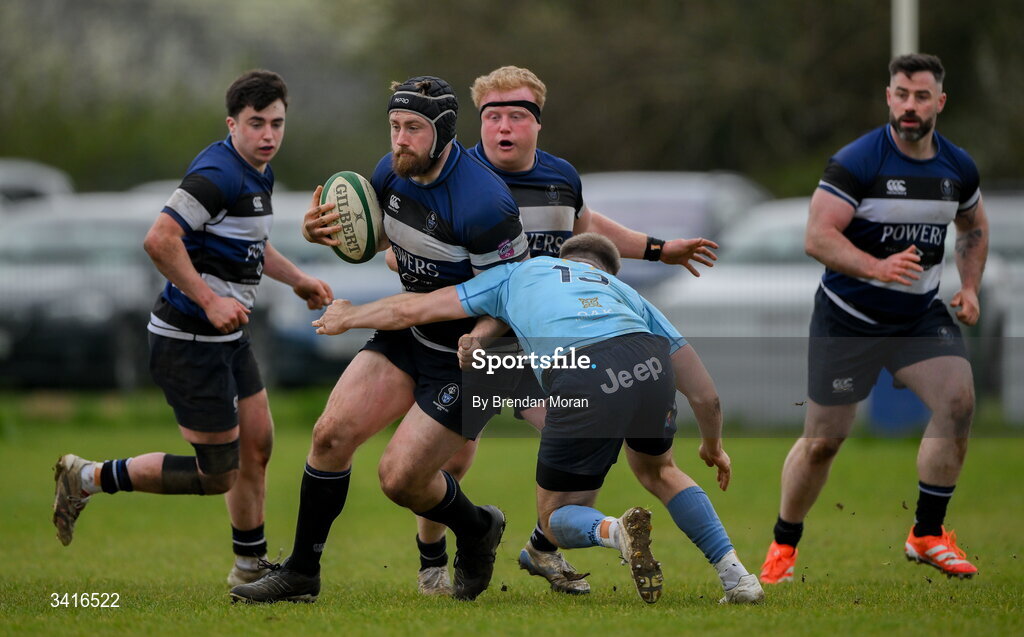 4 April 2026; JJ McIraith of Wanderers is tackled by Shane Mallon of MU Barnhall during the Energia Men's All-Ireland League Division match between MU Barnhall and Wanderers RFC at MU Barnhall RFC in Parsonstown, Kildare. Photo by Brendan Moran/Sportsfile