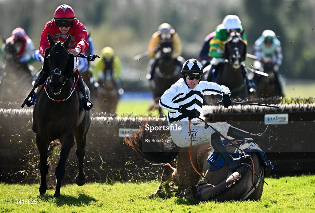 5 April 2026; Royal Soldier and jockey Donagh Meyler, right, fall at the last, as eventual winner Katie Daniels, left, with Ben Harvey up, races clear to win the Cawley Furniture Novice Handicap Hurdle during day two of the Fairyhouse Easter Festival at Fairyhouse Racecourse in Ratoath, Meath. Photo by Seb Daly/Sportsfile