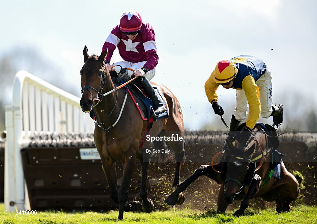 5 April 2026; Blake and jockey Donagh Meyler, right, fall at the last, as eventual winner Koktail Brut, left, with Jack Kennedy up, races clear to win the Donohue Marquees Novice Hurdle during day two of the Fairyhouse Easter Festival at Fairyhouse Racecourse in Ratoath, Meath. Photo by Seb Daly/Sportsfile