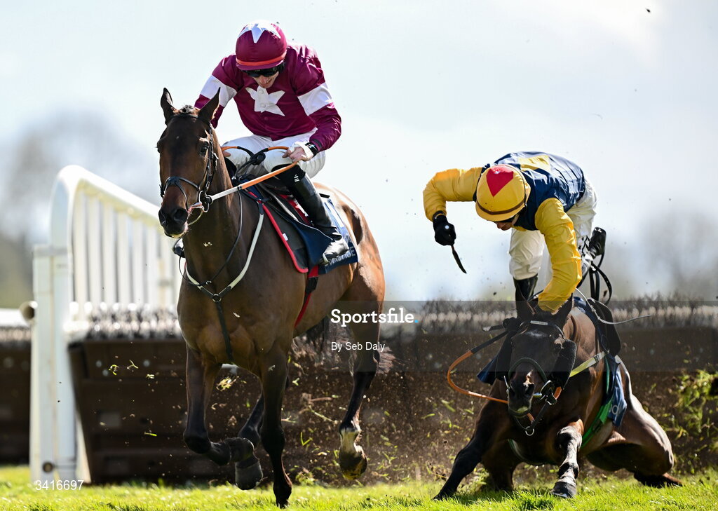 5 April 2026; Blake and jockey Donagh Meyler, right, fall at the last, as eventual winner Koktail Brut, left, with Jack Kennedy up, races clear to win the Donohue Marquees Novice Hurdle during day two of the Fairyhouse Easter Festival at Fairyhouse Racecourse in Ratoath, Meath. Photo by Seb Daly/Sportsfile