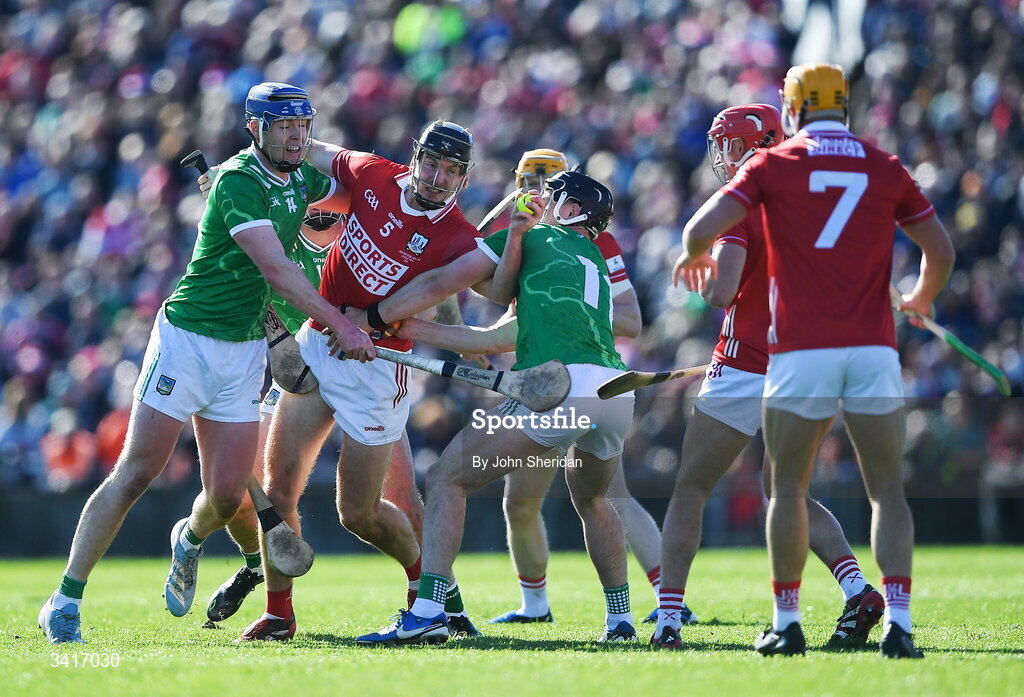 5 April 2026; Eoin Downey of Cork is put under pressure by Limerick players, from left, Shane O'Brien and Aidan O'Connor during the Allianz Hurling League Division 1A final match between Limerick and Cork at TUS Gaelic Grounds in Limerick. Photo by John Sheridan/Sportsfile