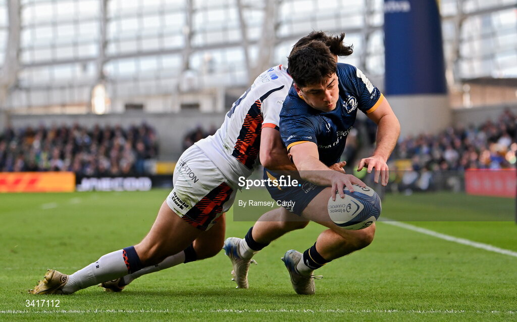 5 April 2026; Jimmy O'Brien of Leinster dives over to score his side's third try despite the attention of Charlie Shiel of Edinburgh during the Investec Champions Cup match between Leinster and Edinburgh at the Aviva Stadium in Dublin. Photo by Ramsey Cardy/Sportsfile